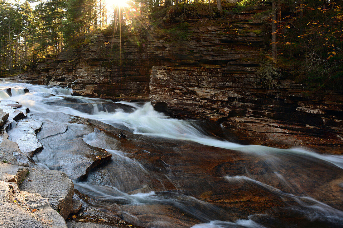 Water cascading over rock at the Lower Ammonoosuc Falls in October.; New Hampshire, USA.
