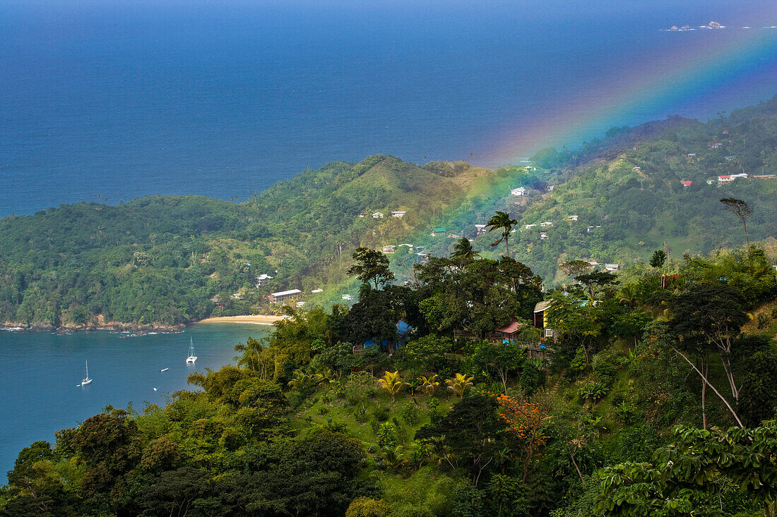 Rainbow arcs above Castara Beach on the island of Tobago; Tobago, Republic of Trinidad and Tobago