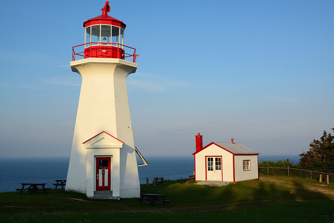 Lighthouse at Cap Gaspe, where the Appalachian Mountains meet the Atlantic ocean.; Forillon National Park, Gaspe Peninsula, Quebec, Canada.