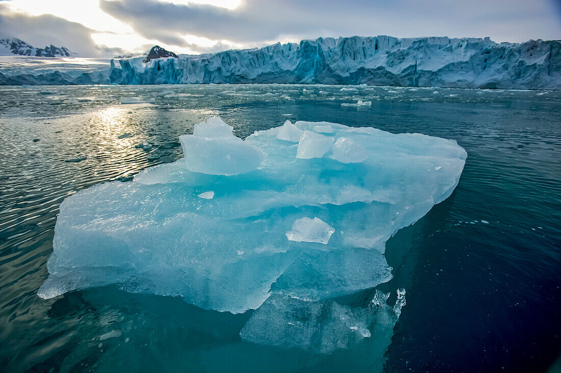 Blue iceberg floating in Lilliehook Fjord; Spitsbergen, Svalbard Archipelago, Norway
