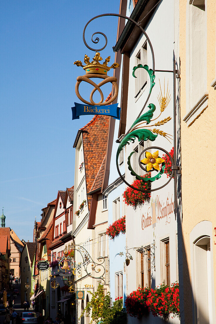 Hanging Sign With Blossoming Flowers In Window Planter Boxes; Rothenburg Ob Der Tauber Bavaria Germany