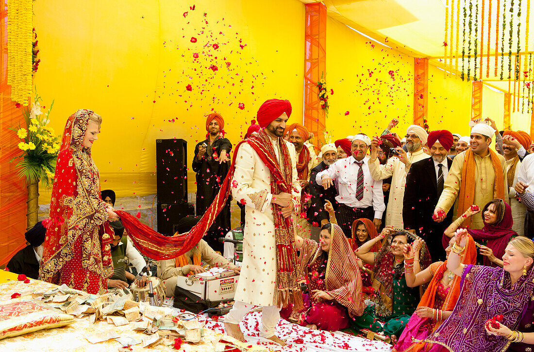 Confetti Being Thrown On A Bride And Groom; Ludhiana, Punjab, India