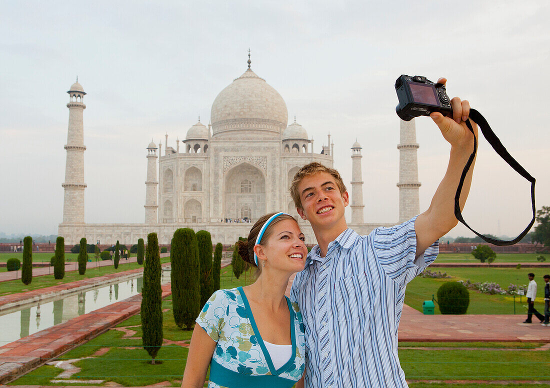 A Young Man And Woman Photograph Themselves With The Taj Mahal In The Background; Agra Uttar Pradesh India