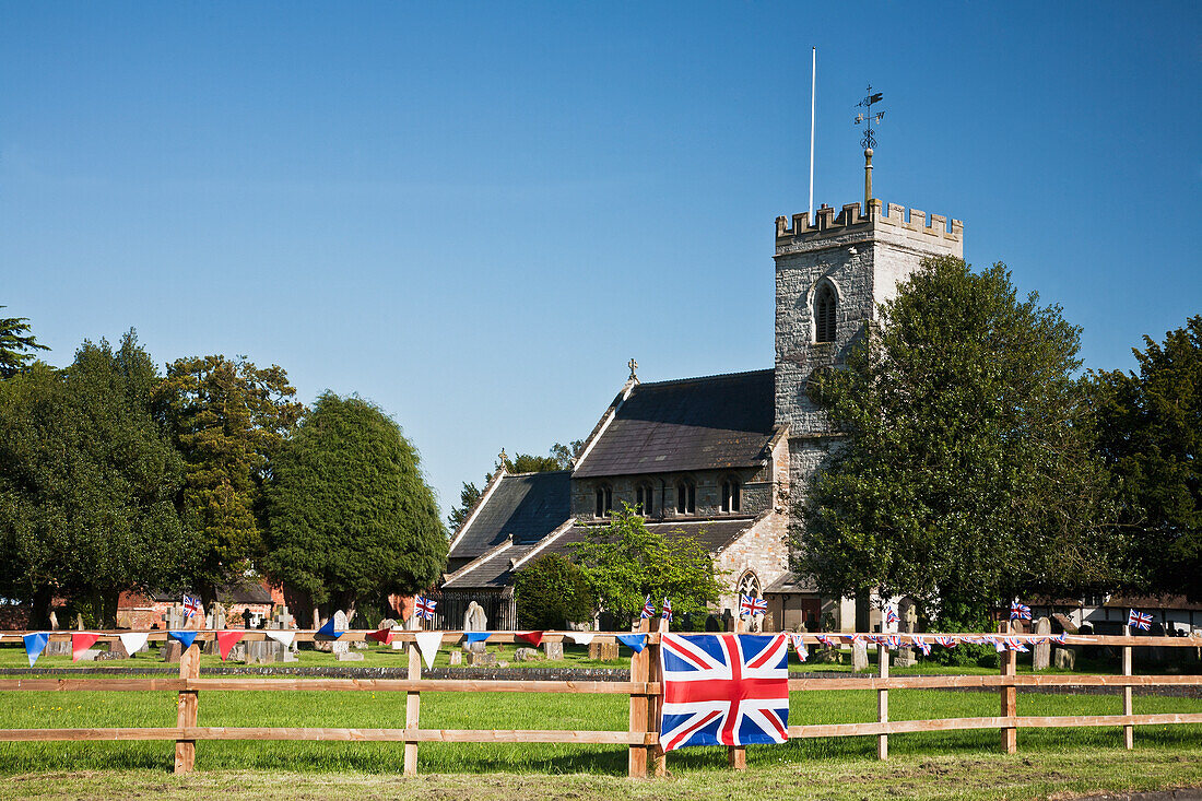 English Village Church And Flag On A Fence; Claverdon Warwickshire England