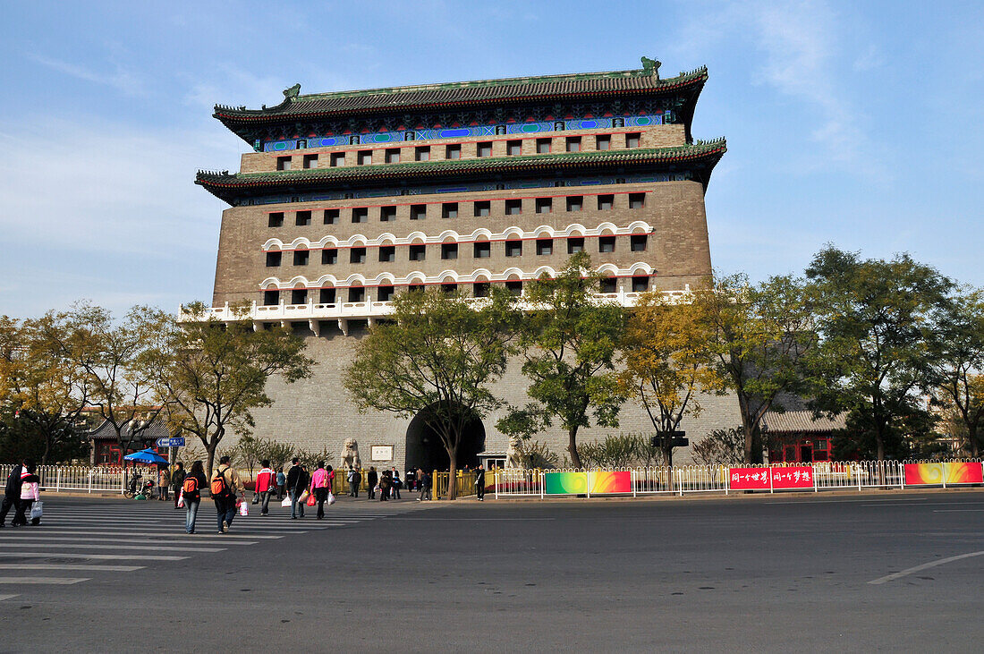 Pedestrians Crossing A Street Towards A Building; Beijing China