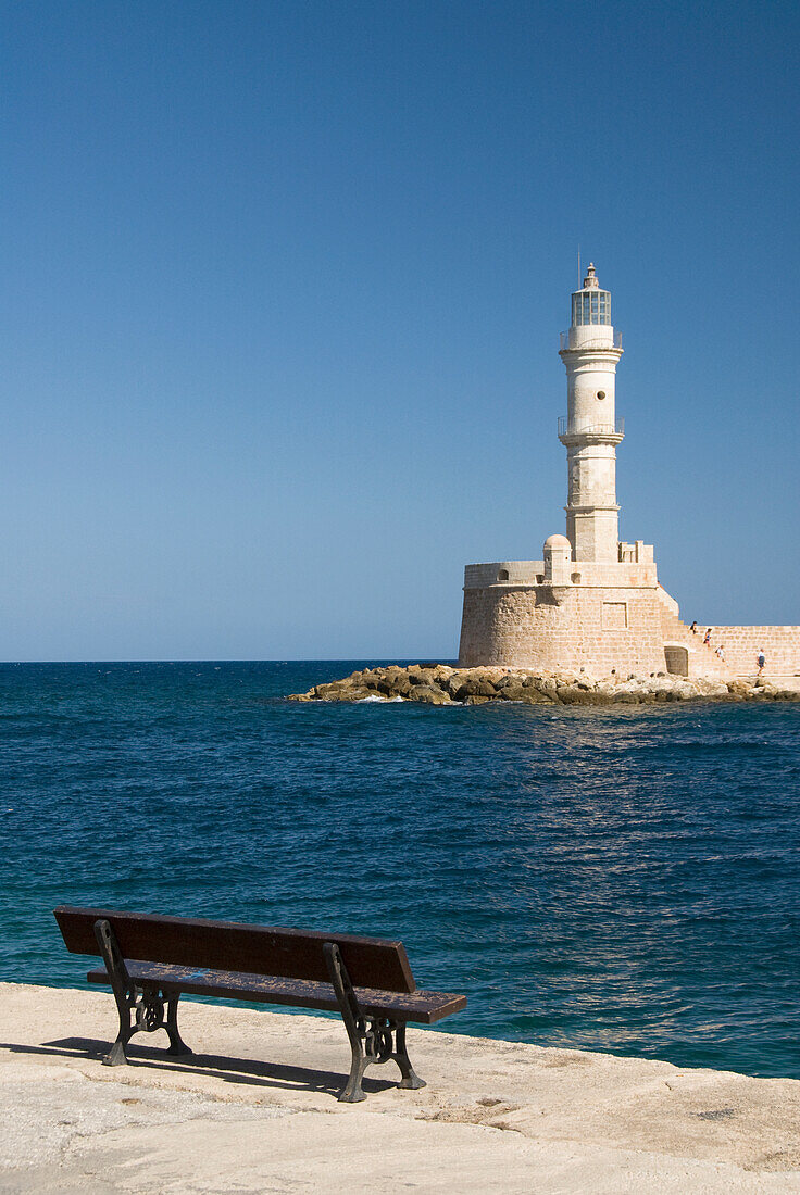 Greece, Crete, Hania, Architectural detail of a bench facing a lighthouse.