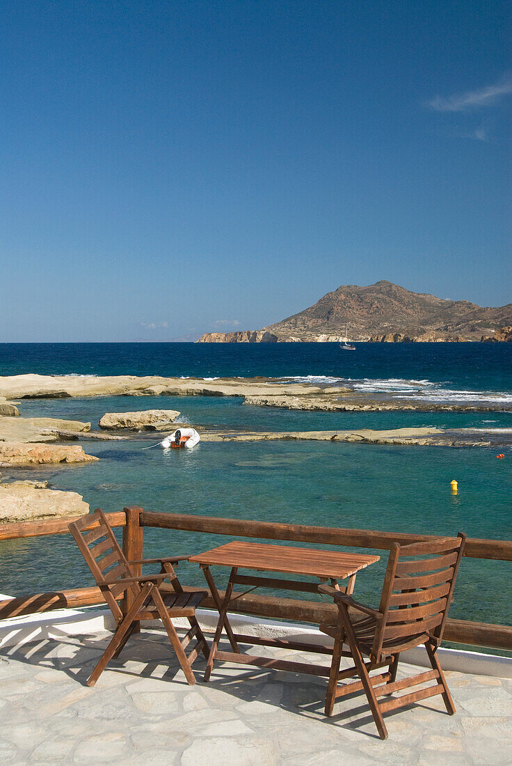 Greece, Cyclades, Island of Milos, Village of Polonia, A table overlooking the bay.