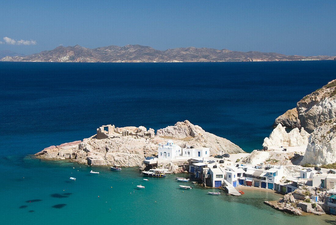 Greece, Cyclades, Island of Milos, Village of Firopotamos, Boats and Buildings near shore.