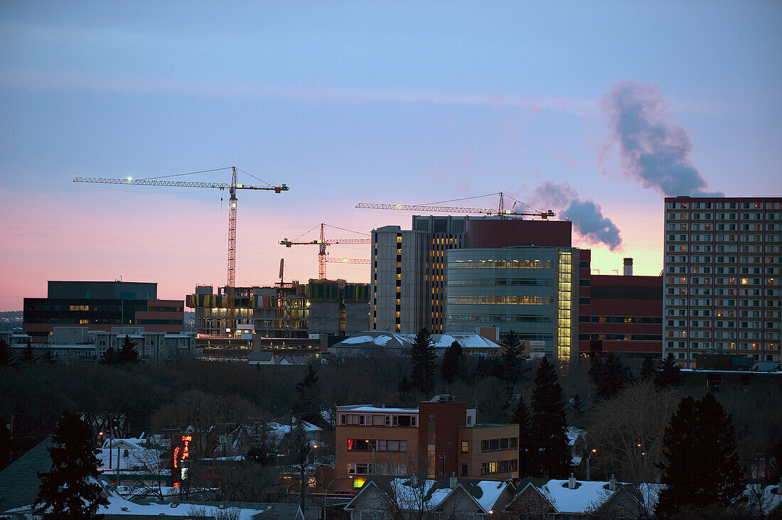 Buildings And Cranes In The Skyline At Dusk; Edmonton Alberta Canada