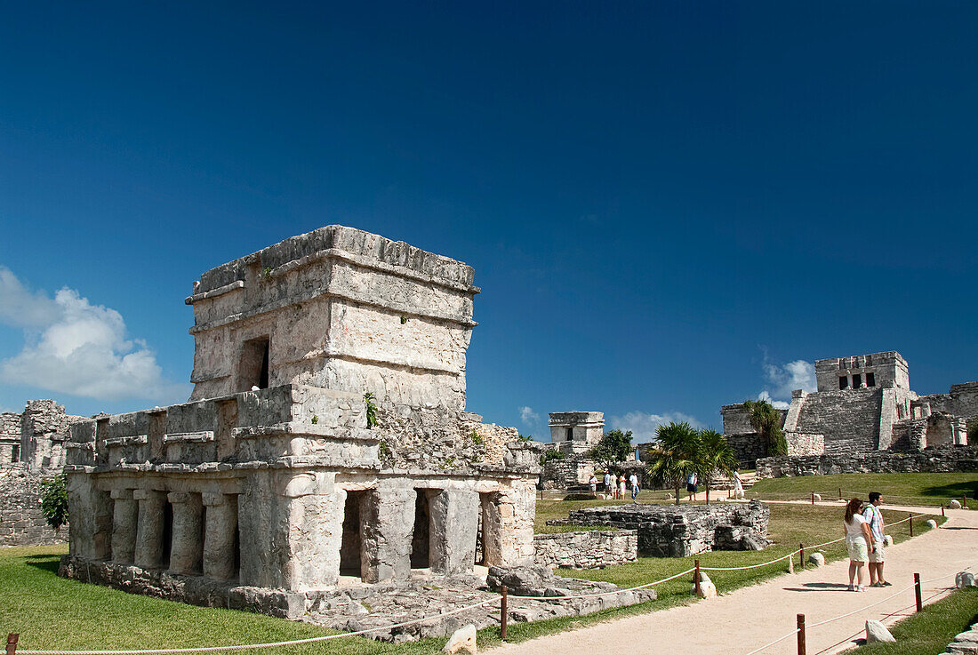 Mexico, Quintana Roo, Tulum, the Mayan ruins of Tulum, Templo de las Pinturas (Temple of Pictures), El Castillo (the Castle) in the background (right), tourist viewing the ruins