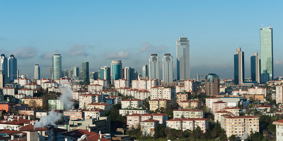Cityscape Of Residential Buildings And Skyscrapers Against A Blue Sky; Istanbul Turkey