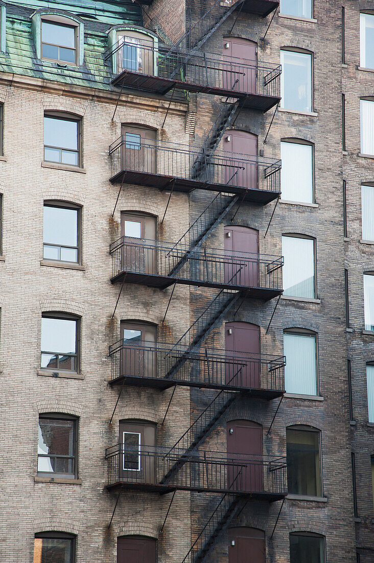Balconies And Stairway On The Side Of A Building; Montreal Quebec Canada