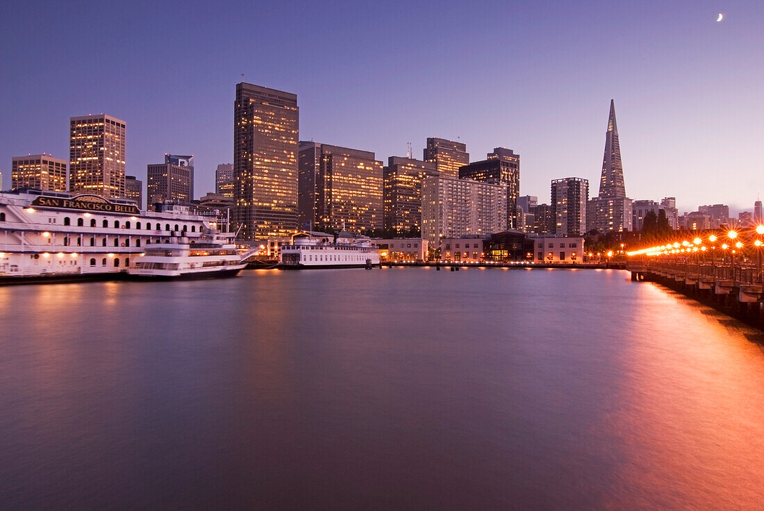 Downtown San Francisco And Water At Sunset Seen From The End Of A Pier; San Francisco California United States Of America