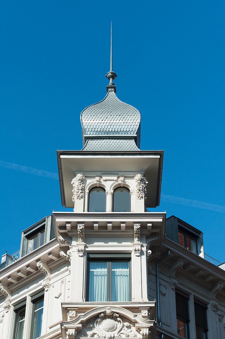 Ornate Facade And Architectural Detail Of A White Building Against A Blue Sky; Zurich Switzerland