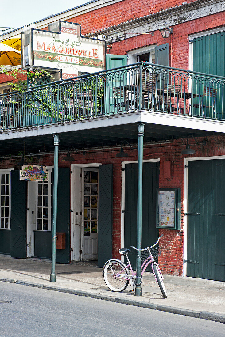 USA, New Orleans, Louisiana, Bicycle leaning on pole outside restaurant