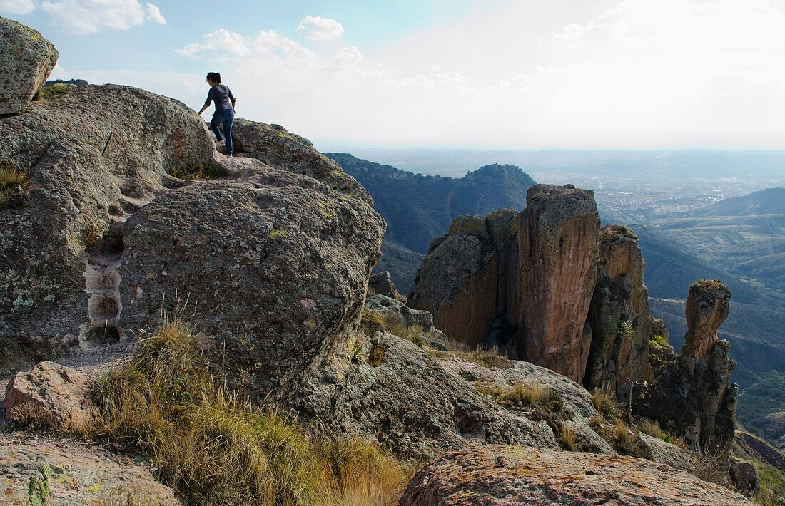 Mexiko, Bundesstaat Guanajuato, Guanajuato, Junge Frau klettert auf den Felsen von La Bufa