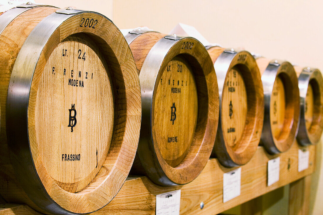 Close up of small oak barrels; Spilamberto, Emilia-Romagna, Italy