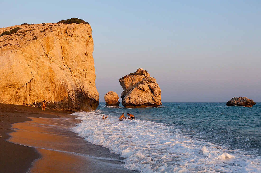 Playing in ocean waves on coast; Aphrodite Bay, Cyprus