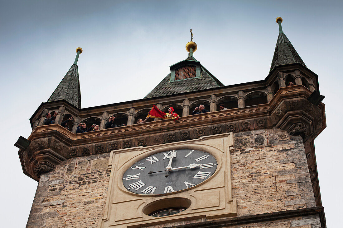 Czech Republic, Low angle view of tourists in clock tower; Prague
