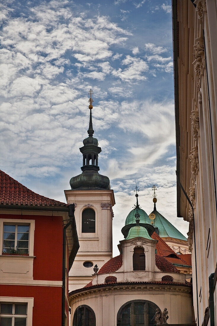 Czech Republic, Buildings with green roofs and spire on tower; Prague