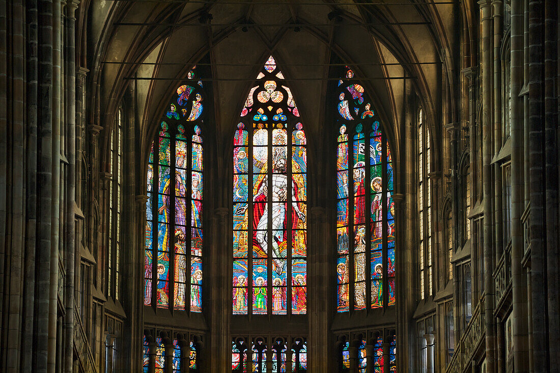 Czech Republic, Colorful stained glass windows with depiction of religious figures; Prague