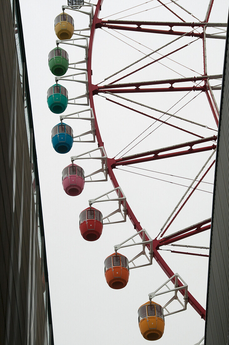 Ferris wheel with colorful passenger cars; Tokyo, Japan