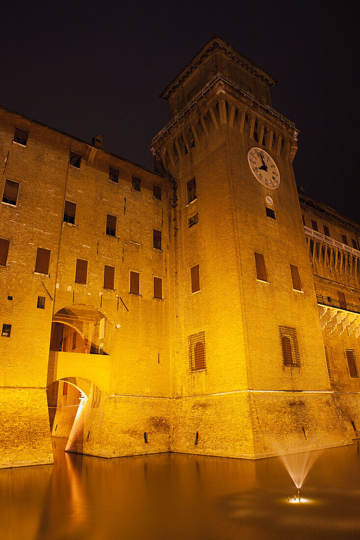 Italy, Emilia-Romagna, Ferrara, Illuminated Castello Estense walls and tower at night
