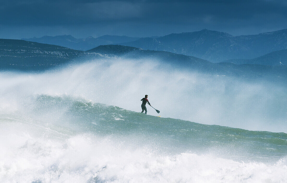 Paddleboarding In The Waves Along The Coast Of Cape Trafalgar; Cadiz, Andalusia, Spain