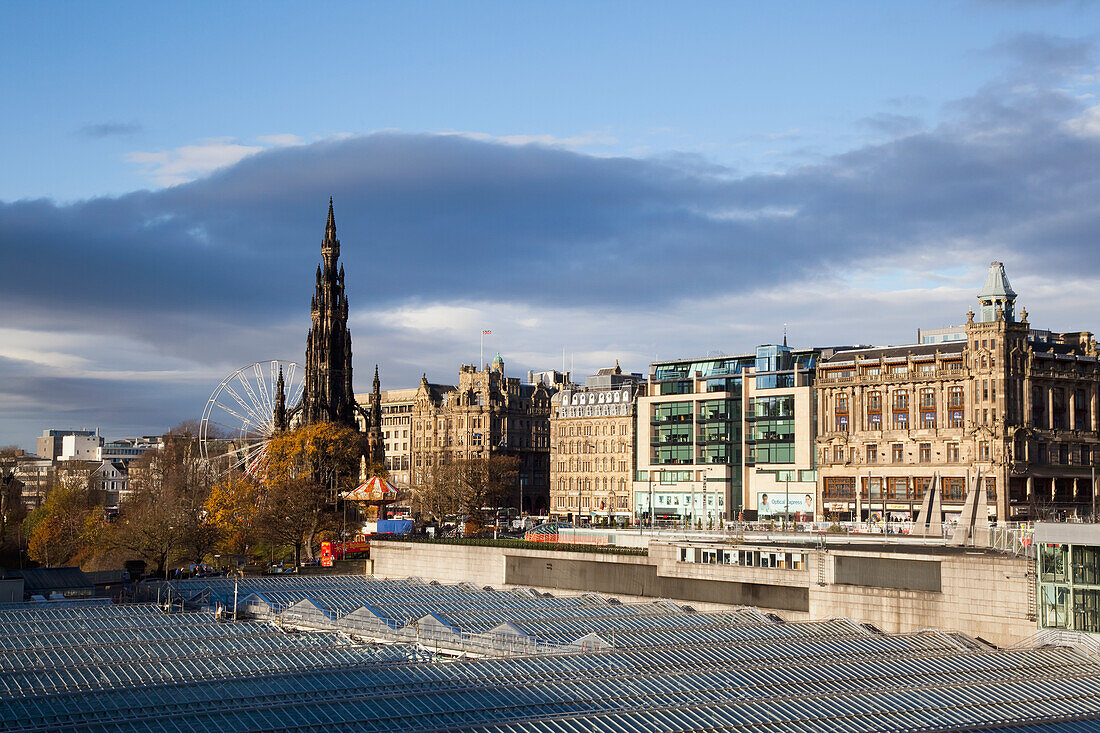 United Kingdom, Scotland, View of roofs and Princess Street Gardens with Scott Monument in background; Edinburgh