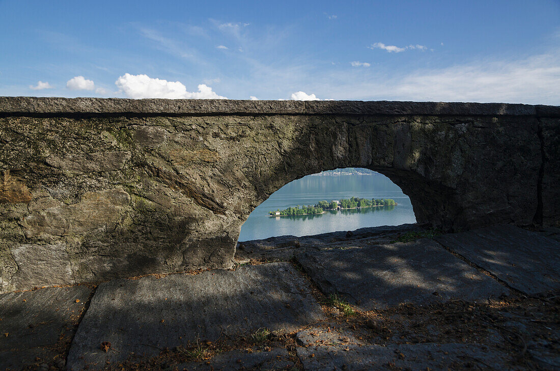 A Wall With An Arched Window With A View Of Lake Maggiore; Isole Di Brissago, Ticino, Switzerland