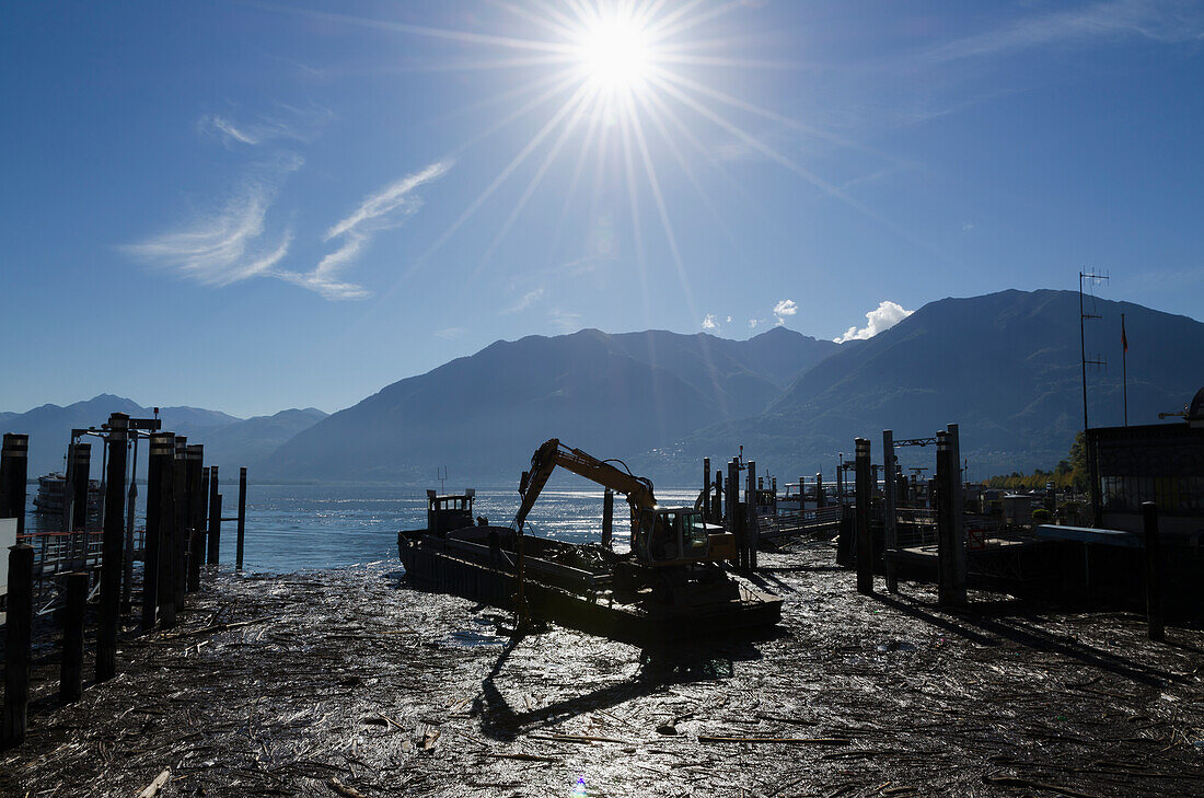 Industrial Equipment On The Shore Of Lake Maggiore On A Sunny Day; Locarno, Ticino, Switzerland