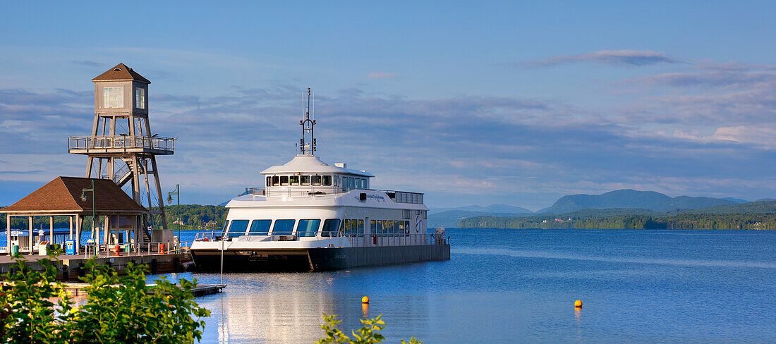 Tour Boat On Lac Memphremagog And An Observation Tower On A Pier; Magog, Quebec, Canada