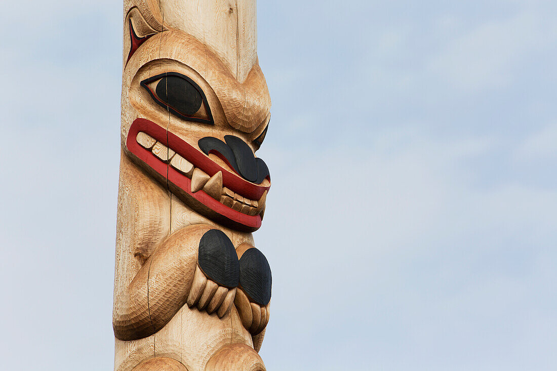 Close Up Of An Animal Carved And Painted On A Totem Pole; Whitehorse, Yukon, Canada