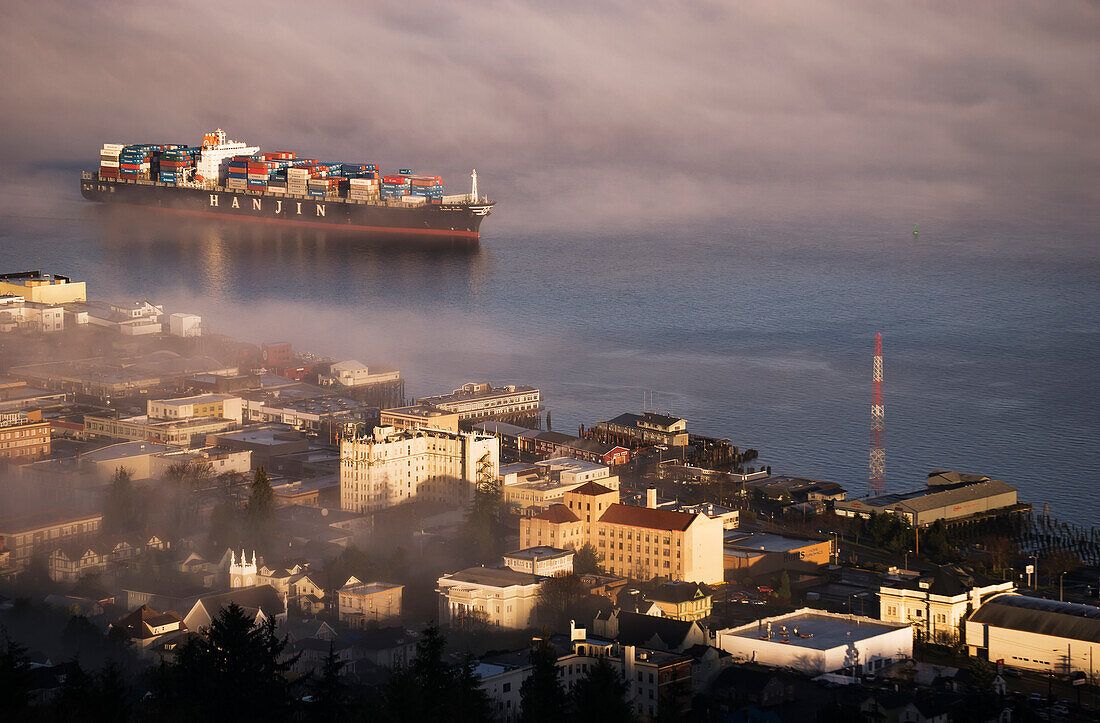 A Container Ship Emerges From The Fog; Astoria, Oregon, United States Of America