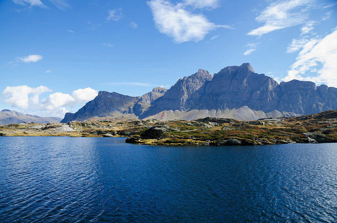 Mountains Along The Shoreline Of An Alpine Lake; San Bernardino, Grisons, Switzerland