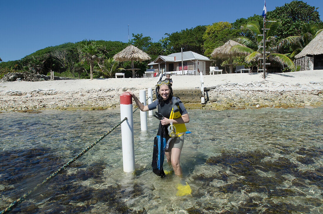 A Woman With Snorkelling Gear At Utopia Village; Utila Island, Honduras