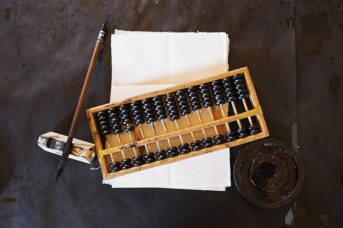 Abacus, fountain pen and parchment paper at Chinese School in Barkerville Historic Town in British Columbia, Canada