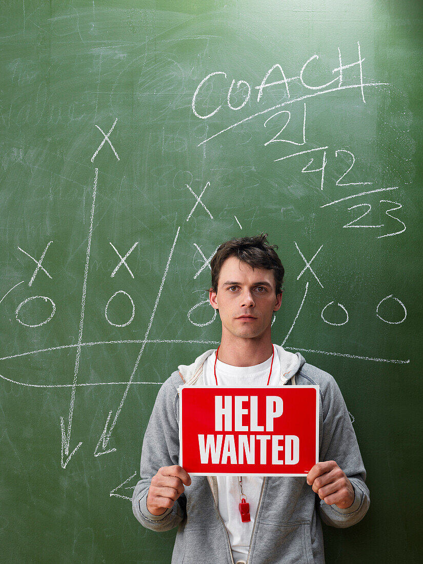 Coach Holding Help Wanted Sign
