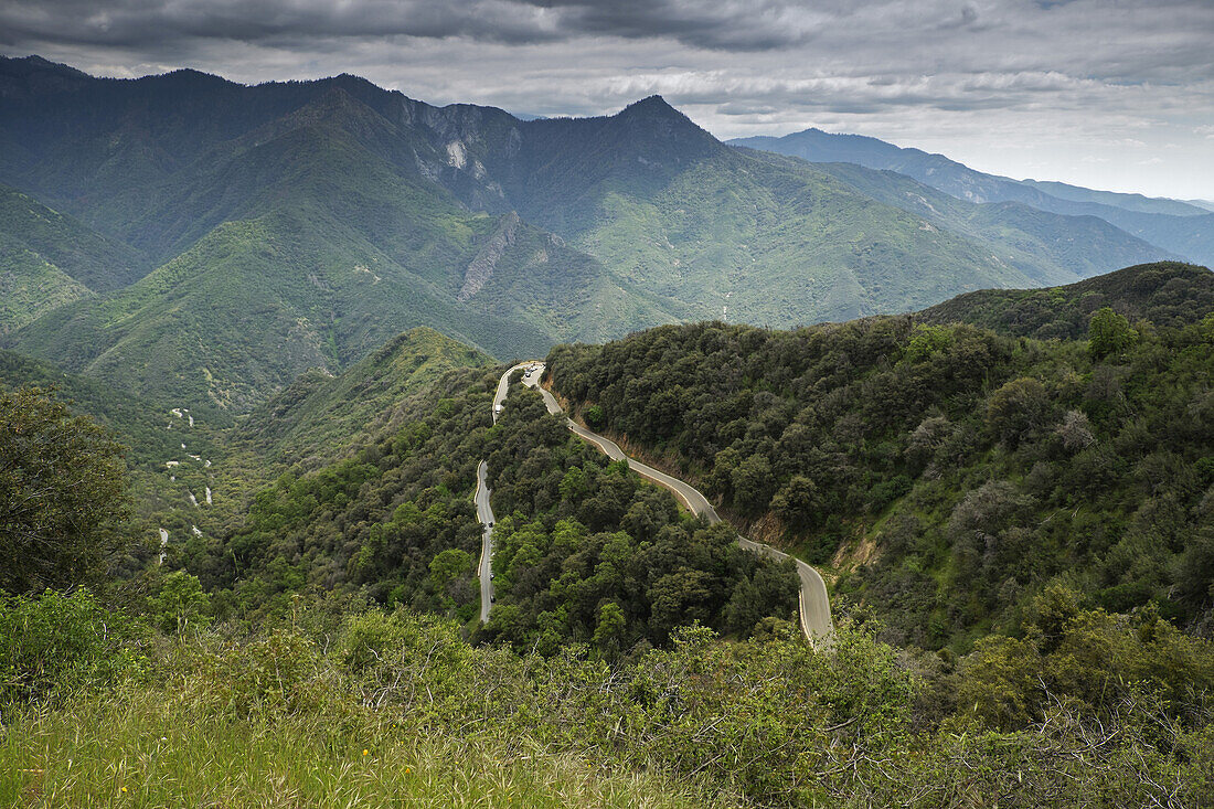 Scenic view of a mountain highway, State Route 41, with Devil's Peak of the Sierra Mountains in the background in California, USA