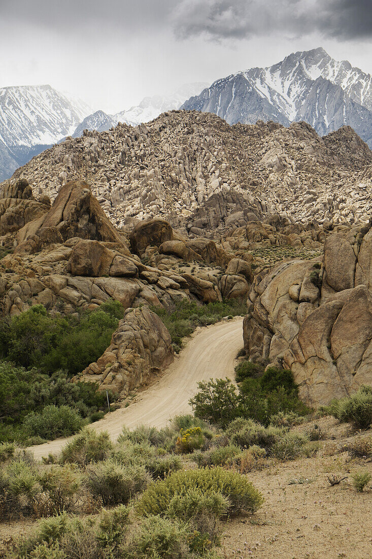 Dirt road through the Alabama Hills with the Sierra Nevada Mountians in the background in Eastern California, USA