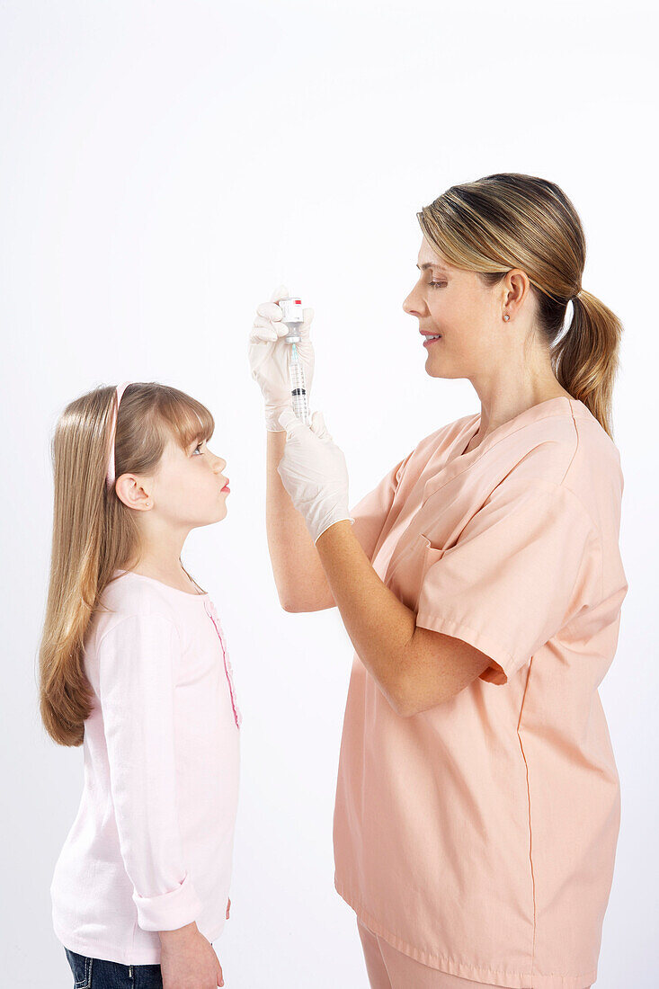 Little Girl Watching Nurse Prepare a Needle