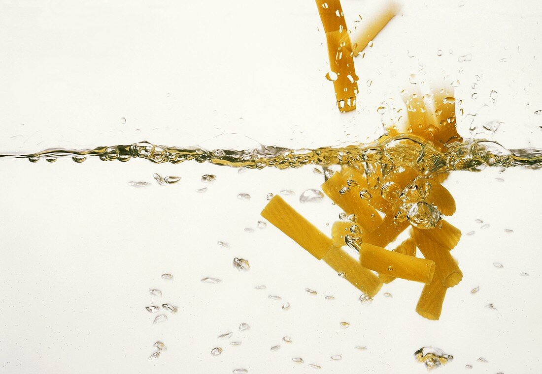 Rigatoni falling into boiling water