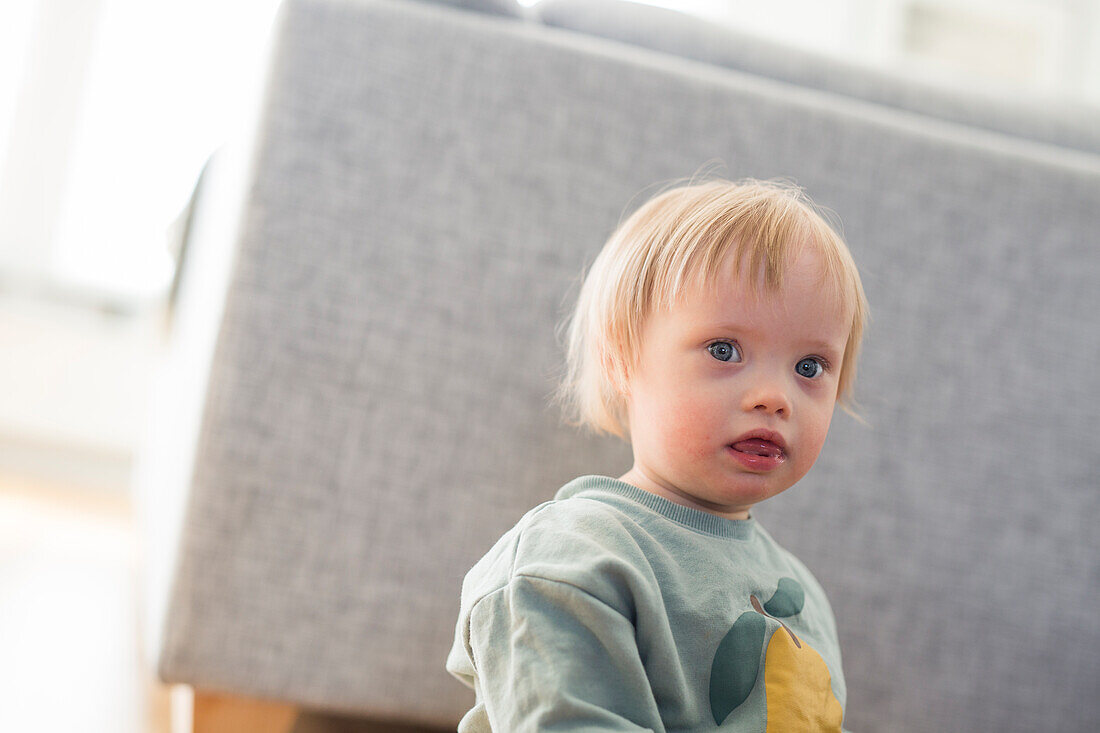 Toddler with down syndrome looking at camera