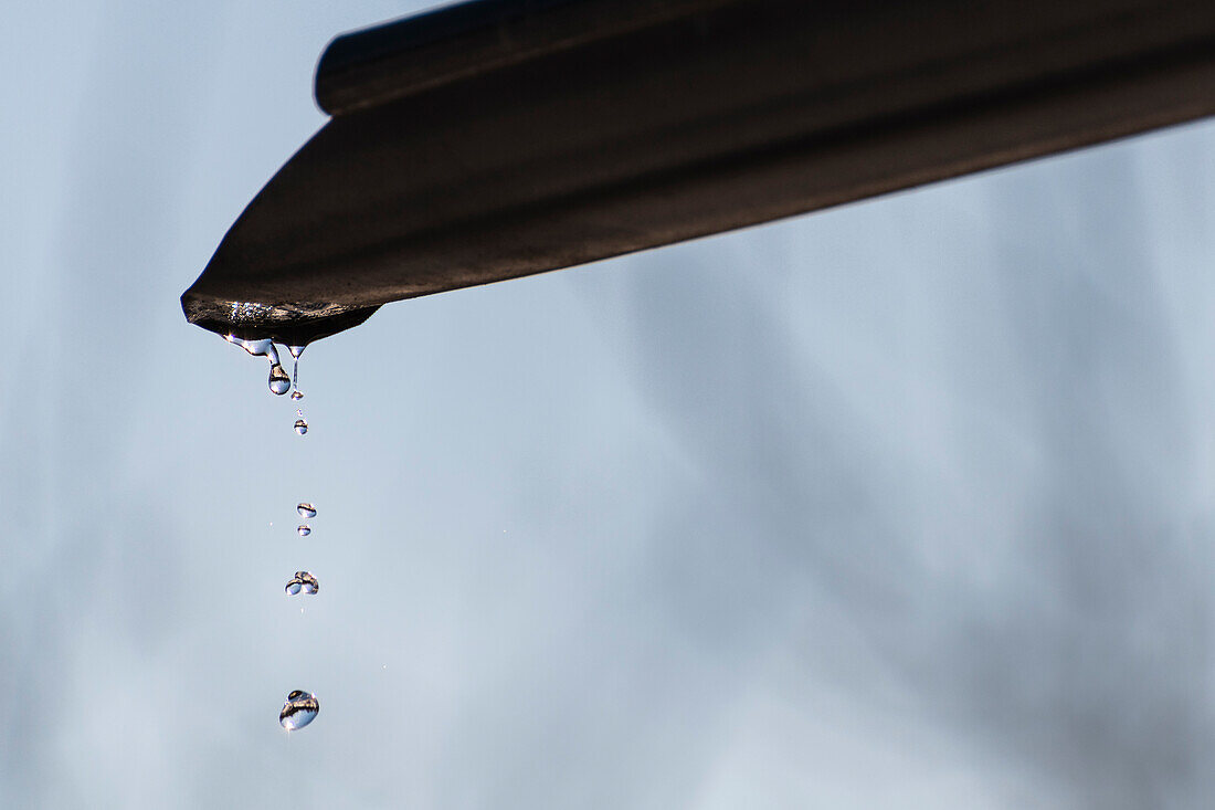 Rain drops dripping from gutter