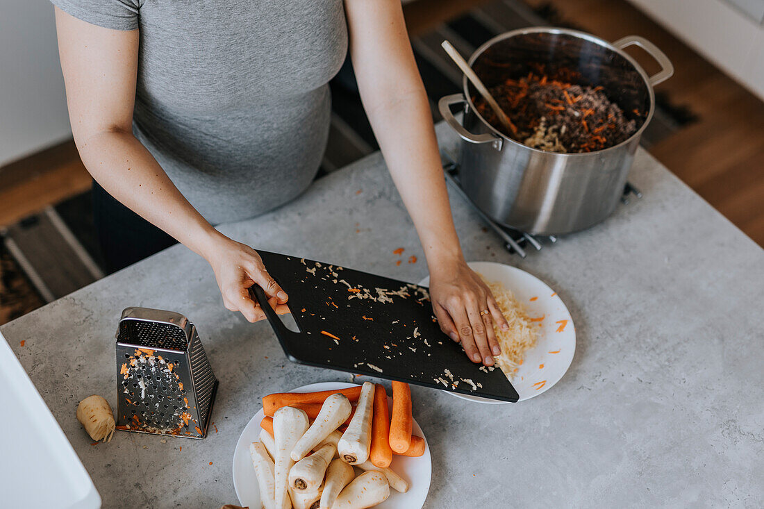 Mid section of woman preparing food, high angle view