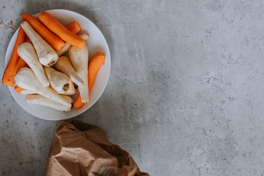 Peeled carrots and parsnips on plate