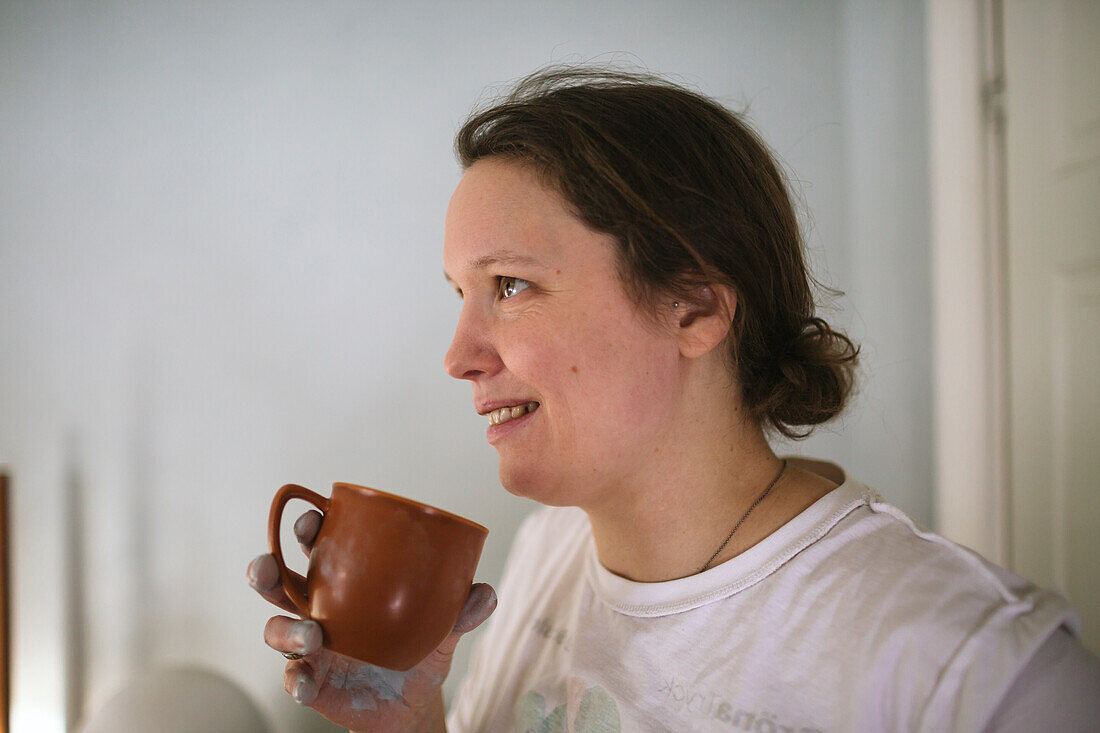 Smiling woman having coffee