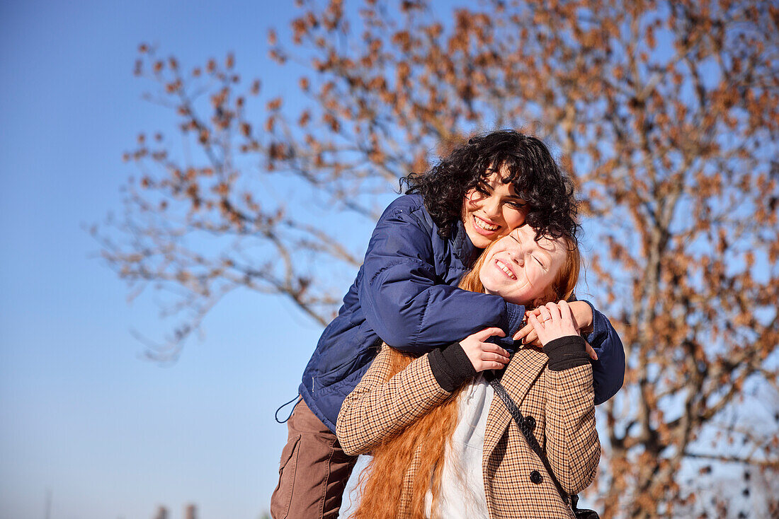 Happy female friends having fun together and hugging each other