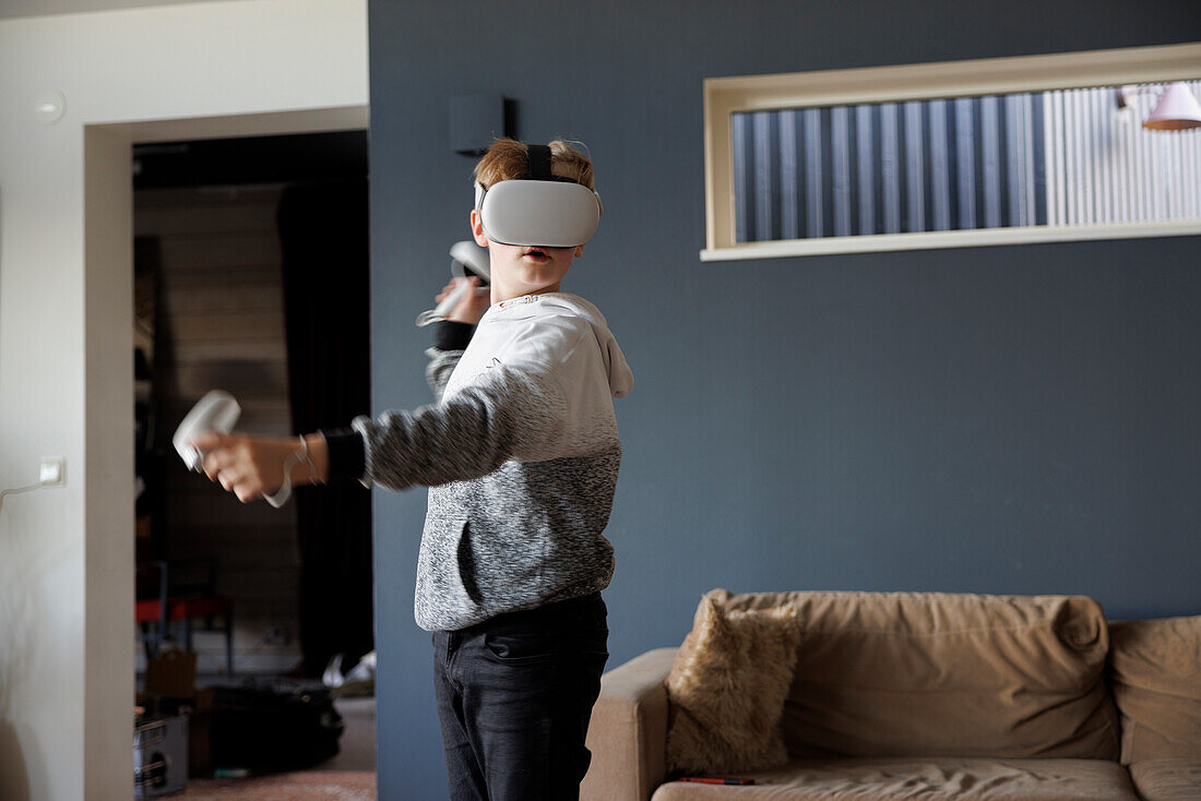 Boy wearing virtual reality goggles during VR experience