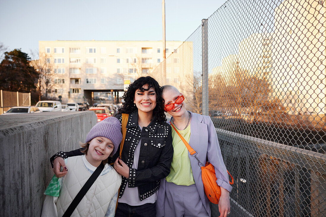 Smiling young woman and girl looking at camera